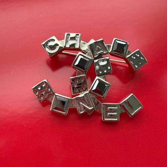 CHANEL Black and Silver Logo Brooch - Picture 1 of 4